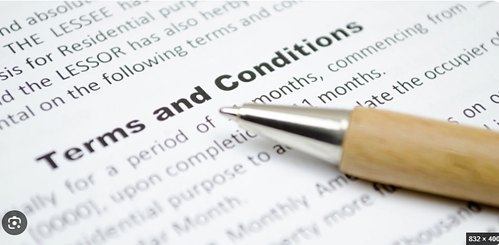 Pen pointing at the words Terms and Conditions on a printed agreement